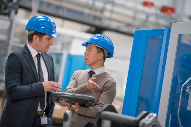 istock Manager and engineer discussing in factory 1205718866