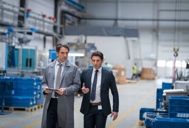 istock Manager and engineer discussing in factory 1205718883