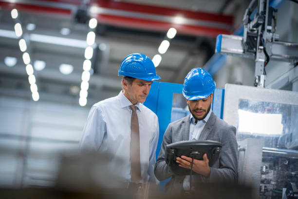 istock Engineer and supervisor discussing in factory 1205718898