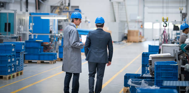istock Manager and engineer walking in factory 1205718899