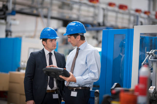 istock Manager and engineer discussing in factory 1205718900
