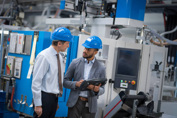 istock Engineer and supervisor discussing in factory 1205718902