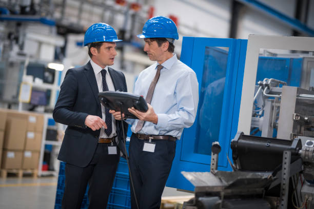 istock Manager and engineer discussing in factory 1205718906