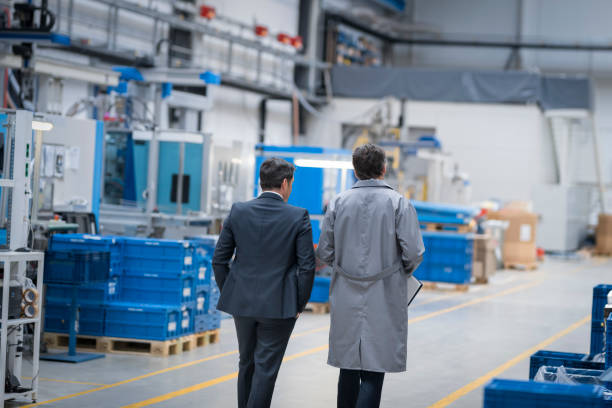 istock Manager and engineer walking in factory 1205718923