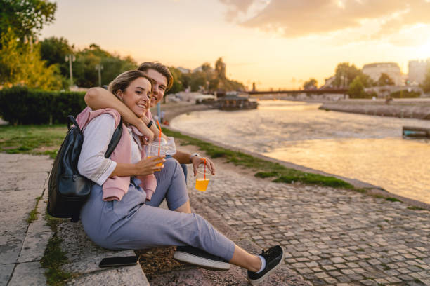 istock Young couple sitting by the river 1205718970