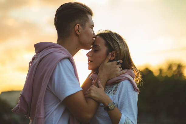 istock Young couple kissing by the river 1205719253
