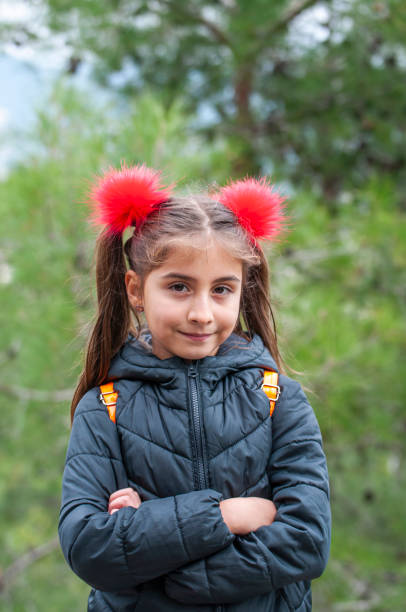 istock Turkish cute little girl posing by garden 1205720302