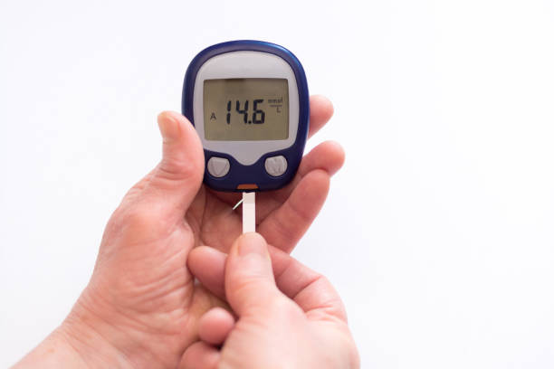 istock close person checking blood sugar with glucometer 1205720757