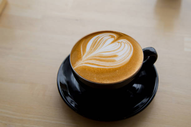 istock Cup of coffee latte on wooden background. Top view. 1205723645