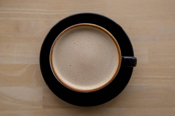 istock Cup of coffee latte on wooden background. Top view. 1205724206