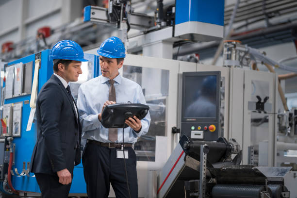 istock Manager and engineer discussing in factory 1205724416
