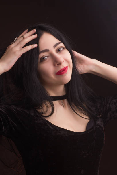 istock brunette on dark background dressed in goth style 1205724511