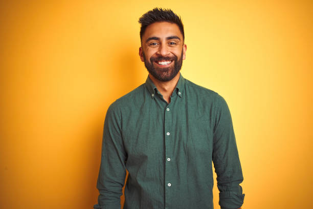 istock Young indian businessman wearing elegant shirt standing over isolated white background with a happy and cool smile on face. Lucky person. 1205724708