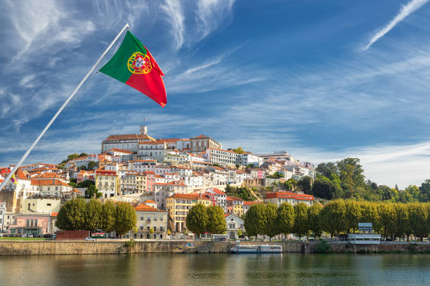 view on the old university city of coimbra and the medieval capital of portugal with portuguese flag. europe - portugal turismo imagens e fotografias de stock