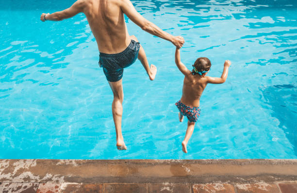istock Father and son having fun on the pool 1205729894
