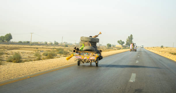 istock a small slow speed vehicle running on a fast highway 1205730914