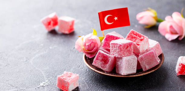 Turkish delight, rose flavour in a copper plate with Turkish flag. Grey stone background. Copy space.