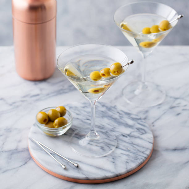istock Martini cocktail with olives and bar shaker on marble table background. 1205733102