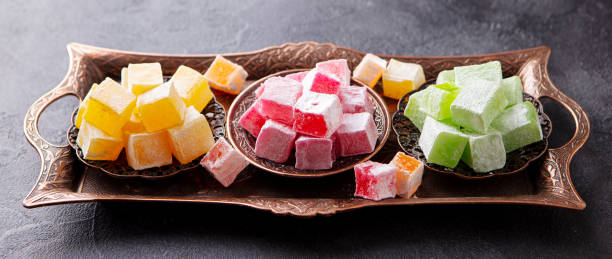 istock Assortment of Turkish delights on a authentic copper tray. Dark background. Close up. 1205733220