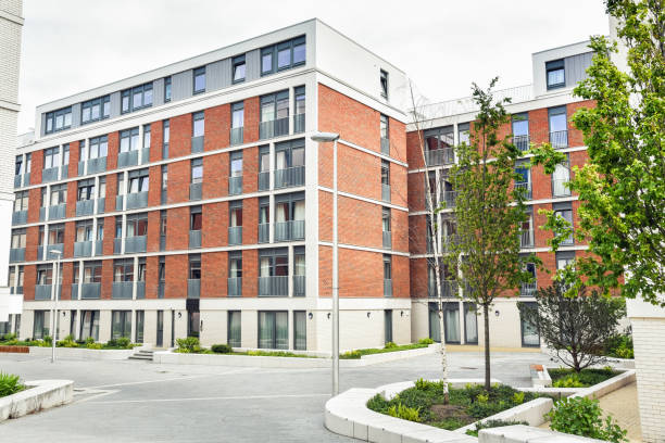 istock Modern brick apartment building and cloudy sky 1205733279