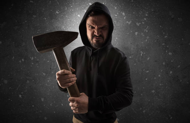 istock Armed villain in an empty dark room 1205733539