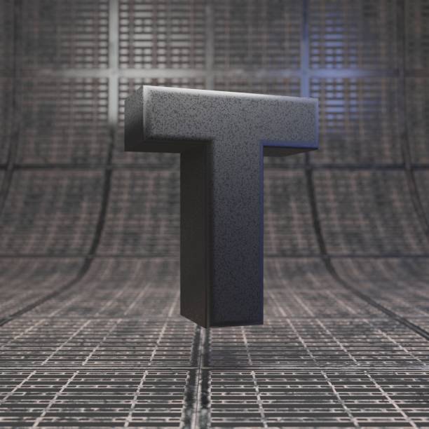 istock Black letter T uppercase. DLSR camera body plastic texture alphabet on metal floor. 1205733801