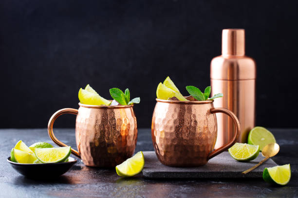 istock Cold Moscow Mules cocktail with ginger beer, vodka, lime and mint. Grey stone background. Copy space. 1205734936