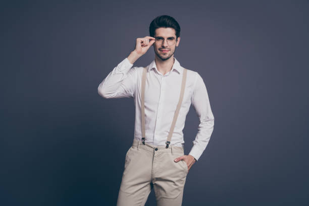 istock Portrait of nice attractive professional imposing serious content brunet guy global organization company owner touching specs posing isolated on grey pastel color background 1205735314