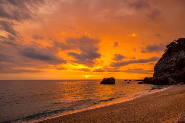 istock Multicolor Sea Sunrise on a Small Beach 1205736502