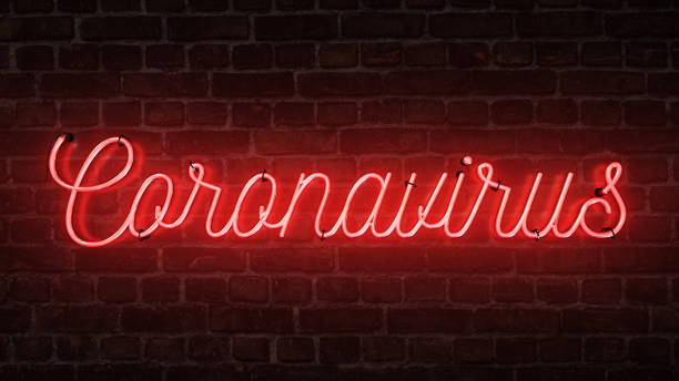 istock Bright red neon sign that says the word Coronavirus on a brick wall. 1205736531
