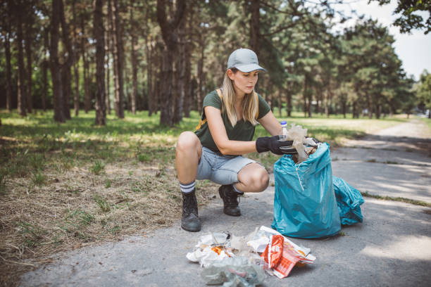 istock Volunteer cleaning park 1205737261