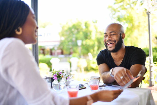 istock Young couple Laughing together in a restaurant 1205739009