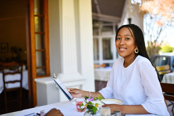 istock Confident Beautiful Young Woman in Restaurant looking at camera 1205739246