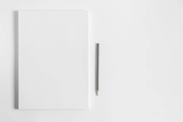 Blank sheets of paper and pencil on white background. Artist workplace. White paper stack with copy space.  Art school template for advertising.