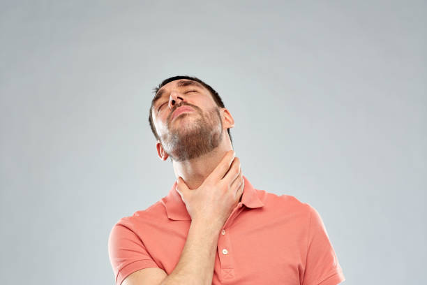istock man touching neck and suffering from throat pain 1205739890