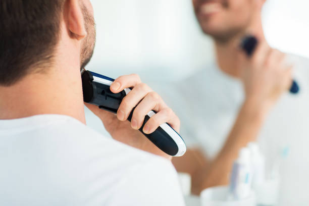 istock close up of man shaving beard with trimmer 1205740016
