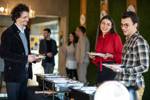 istock Happy business people serving themselves at buffet 1205741631