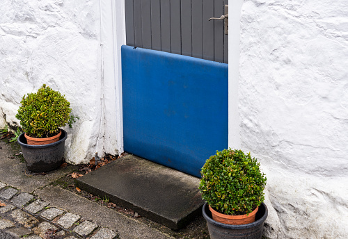 A basic flood prevention barrier Installed outside the front door of a house.