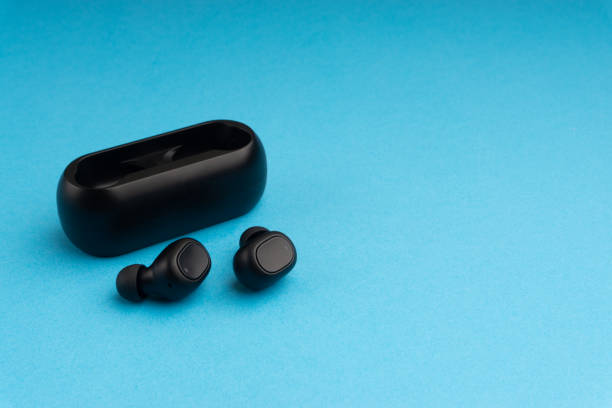 istock Wireless earbuds or earphones on blue background 1205742620