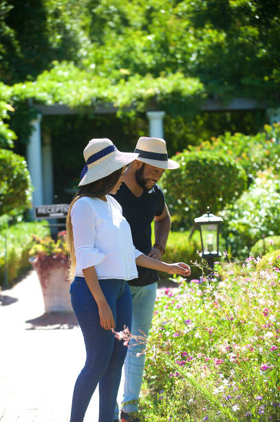 istock Smelling the flowers laughing together 1205742671