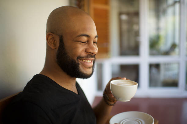 istock Millennial man having coffee laughing eyes closed 1205742725