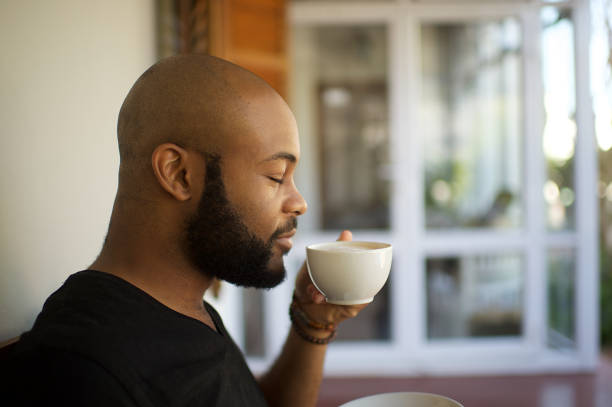 istock Millennial man smelling coffee in a cup 1205742734