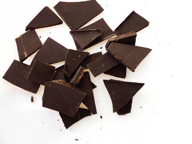 dark chocolate pieces on white background