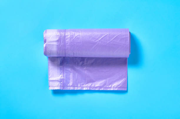 istock One purple disposable plastic garbage bag on blue background. Top view. Close-up 1205743253