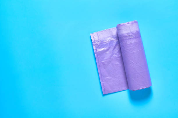 istock One purple disposable plastic garbage bag on blue background. Copy space. Top view 1205743255
