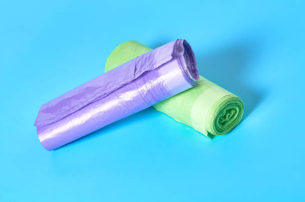 istock Two roll of disposable plastic garbage bag on blue background. Close-up 1205743268