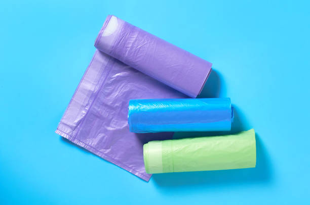 istock Scattered rolls of disposable plastic garbage bag on blue background. Top view. Close-up 1205743341
