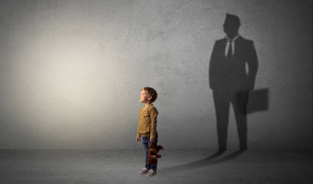 istock Little boy with businessman shadow 1205743366