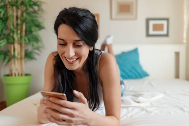 istock Beautiful Young Lady Holding Mobile Phone 1205747187