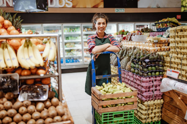 istock Female employee in supermarket 1205747304